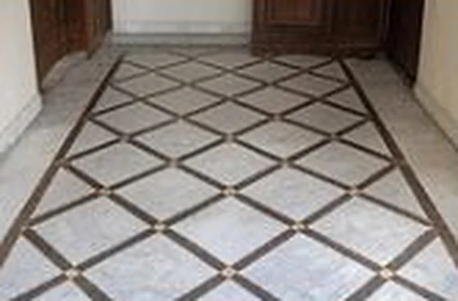 White marble floor with a brown diamond inlay pattern